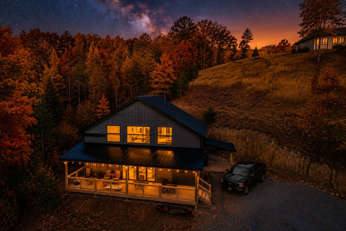 Harbor Point Hideaway at dusk, industrial-farmhouse barndominium on Douglas Lake, sleeping 10 across 3 bedrooms