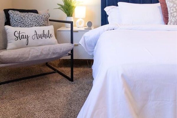 Cozy, spacious room with a queen-sized bed, TV, and a dedicated working space.