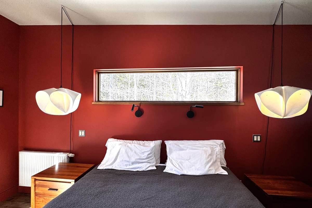 Wake up to nature with this unique forest-view clerestory window. Positioned perfectly above the King bed, this architectural detail provides complete privacy while framing the ever-changing colors of the Acadia woodlands just outside.