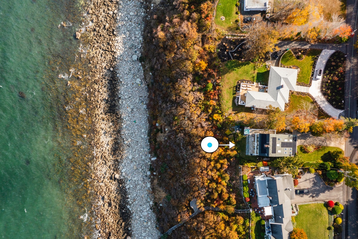 Bird’s-eye view showcasing the house and sparkling coastal waters
