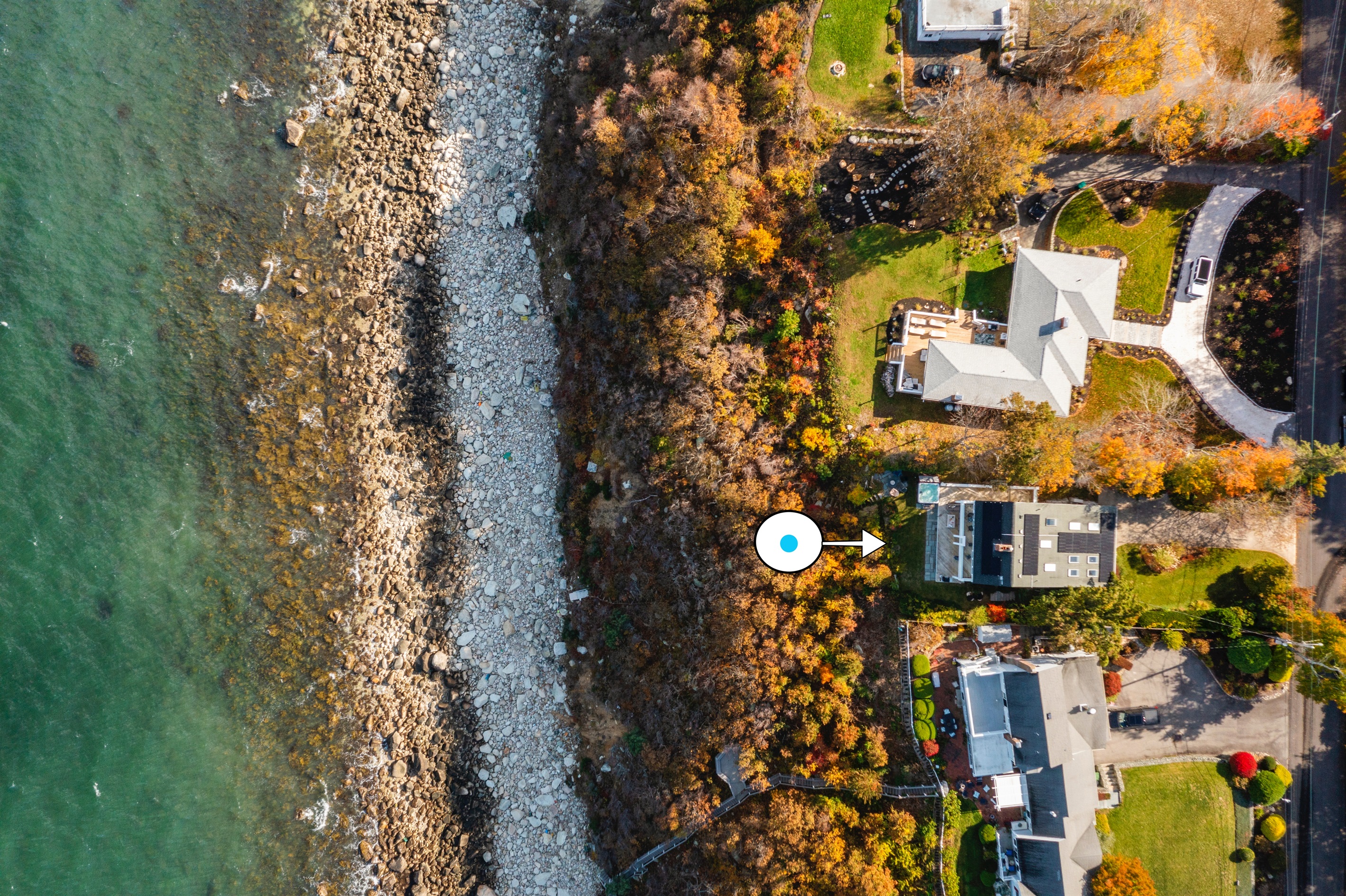 Bird’s-eye view showcasing the house and sparkling coastal waters