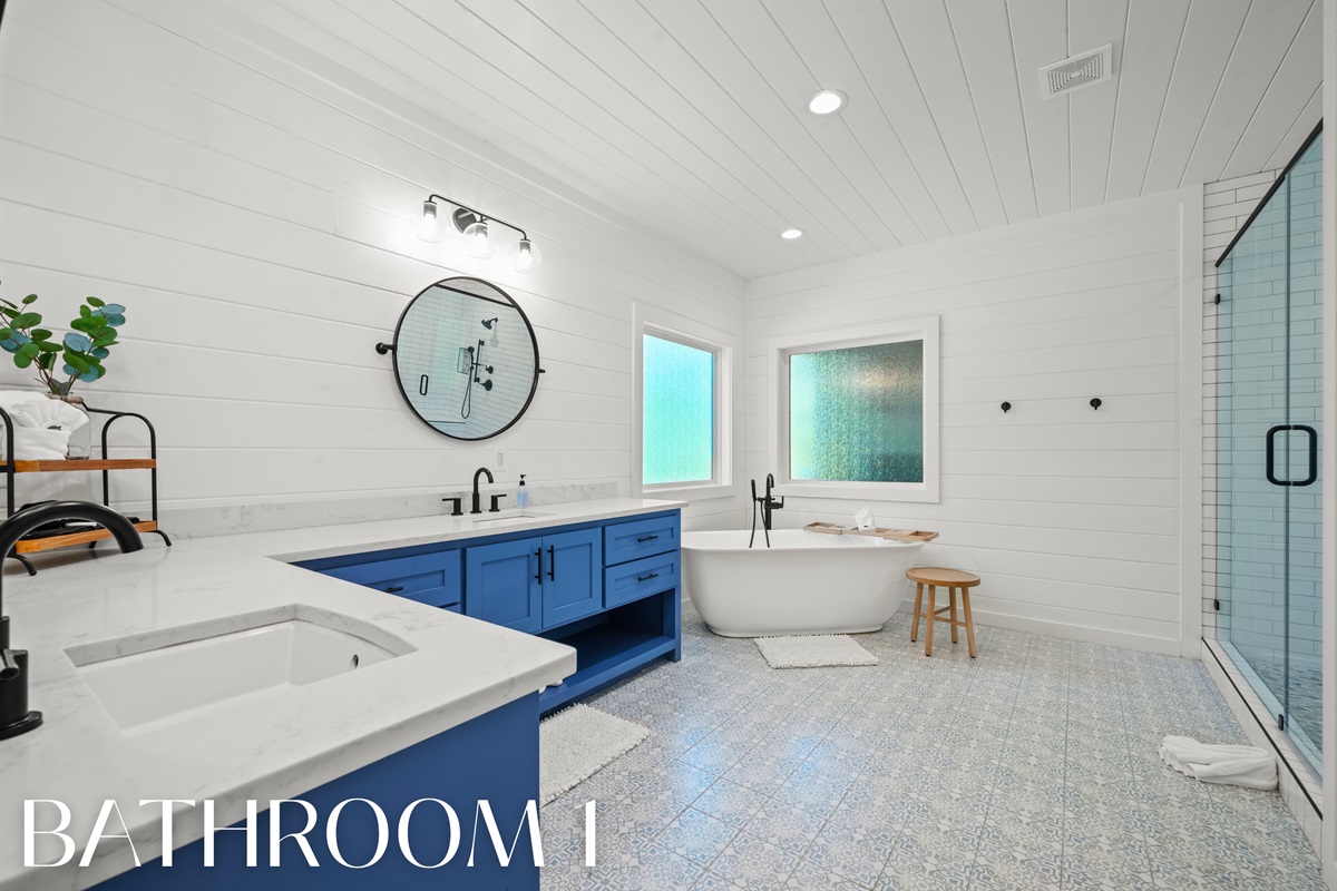 Bathroom 1 with double vanity, soaking tub, and walk-in shower.