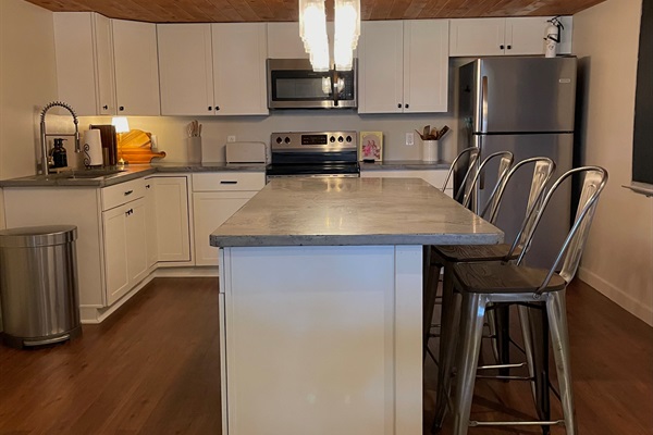 Kitchen includes stove, microwave, refrigerator, and all cooking essentials