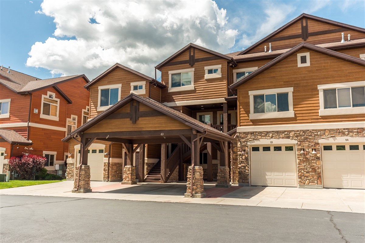 Charming exterior with rich wood and stone finishes, set within a peaceful and beautifully maintained neighborhood.