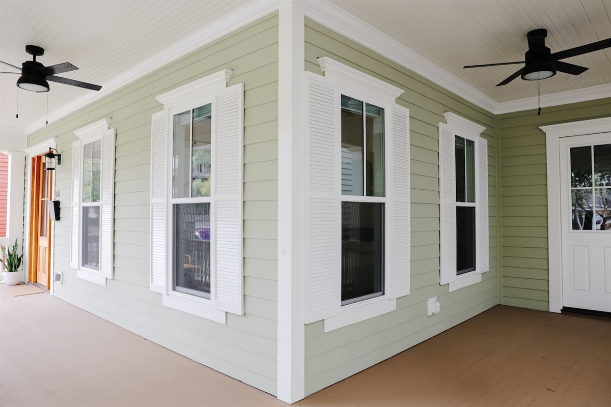 The wraparound front porch with three fans makes for a great spot to dine al fresco or relax with a cocktail. **will feature outdoor seating and dining table**