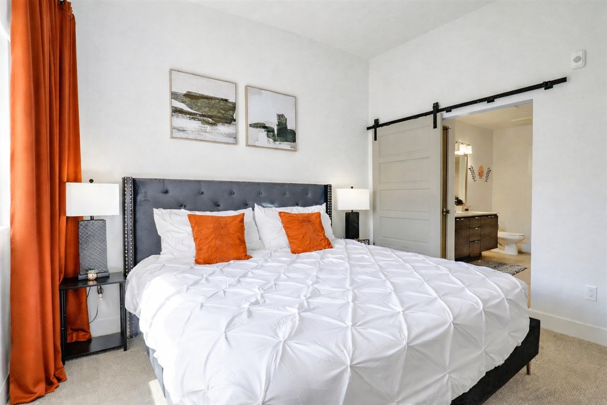 Peaceful bedroom with a comfortable bed, quality linens, and a calm, relaxing ambiance. A simple, clean space designed to help you unwind and enjoy a restful night’s