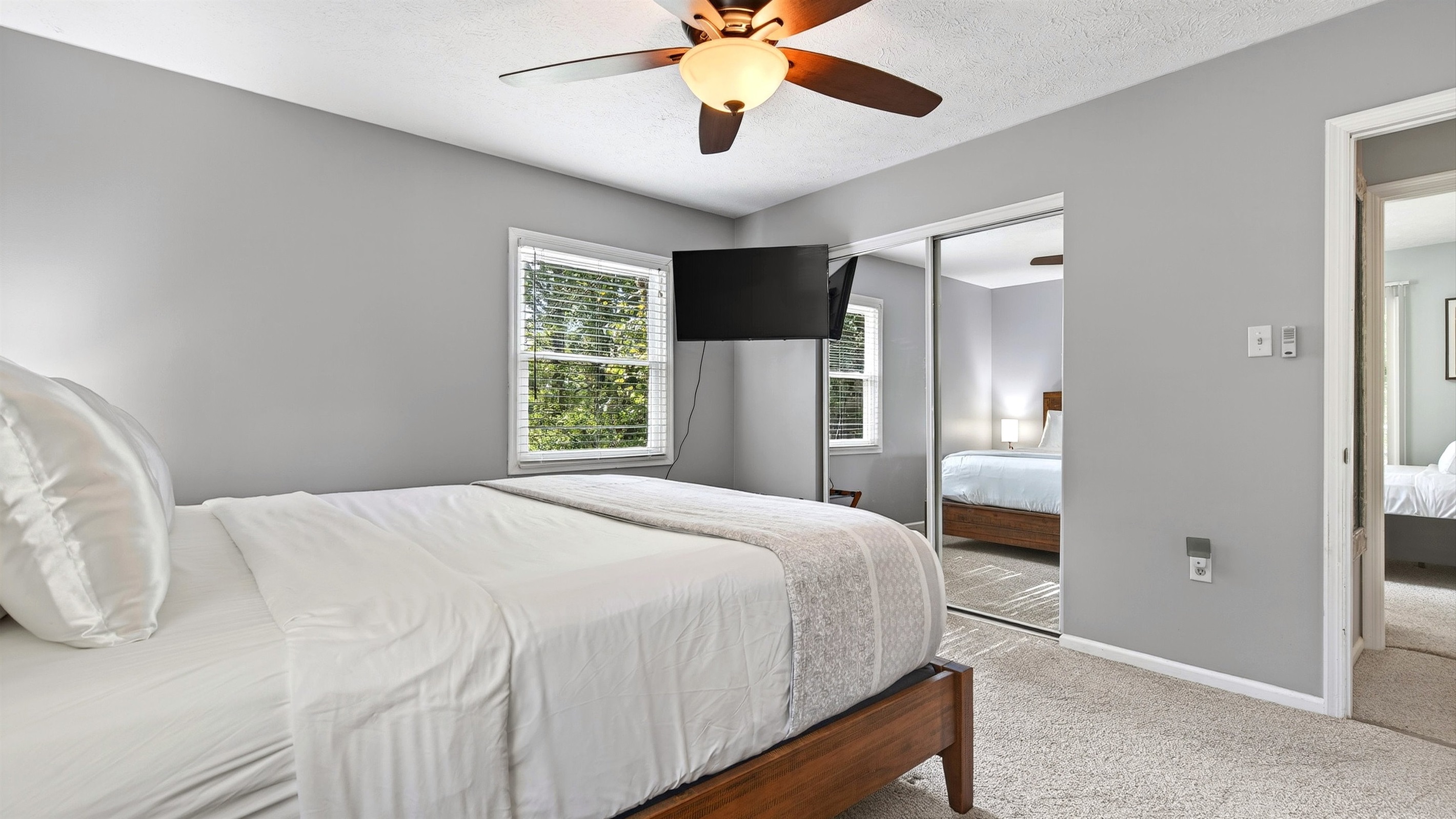 Main level master bedroom also features a TV.