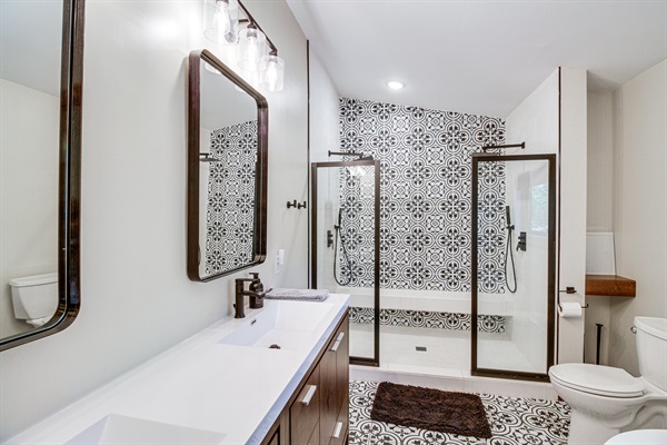 Full bathroom with walk-in shower and double vanity