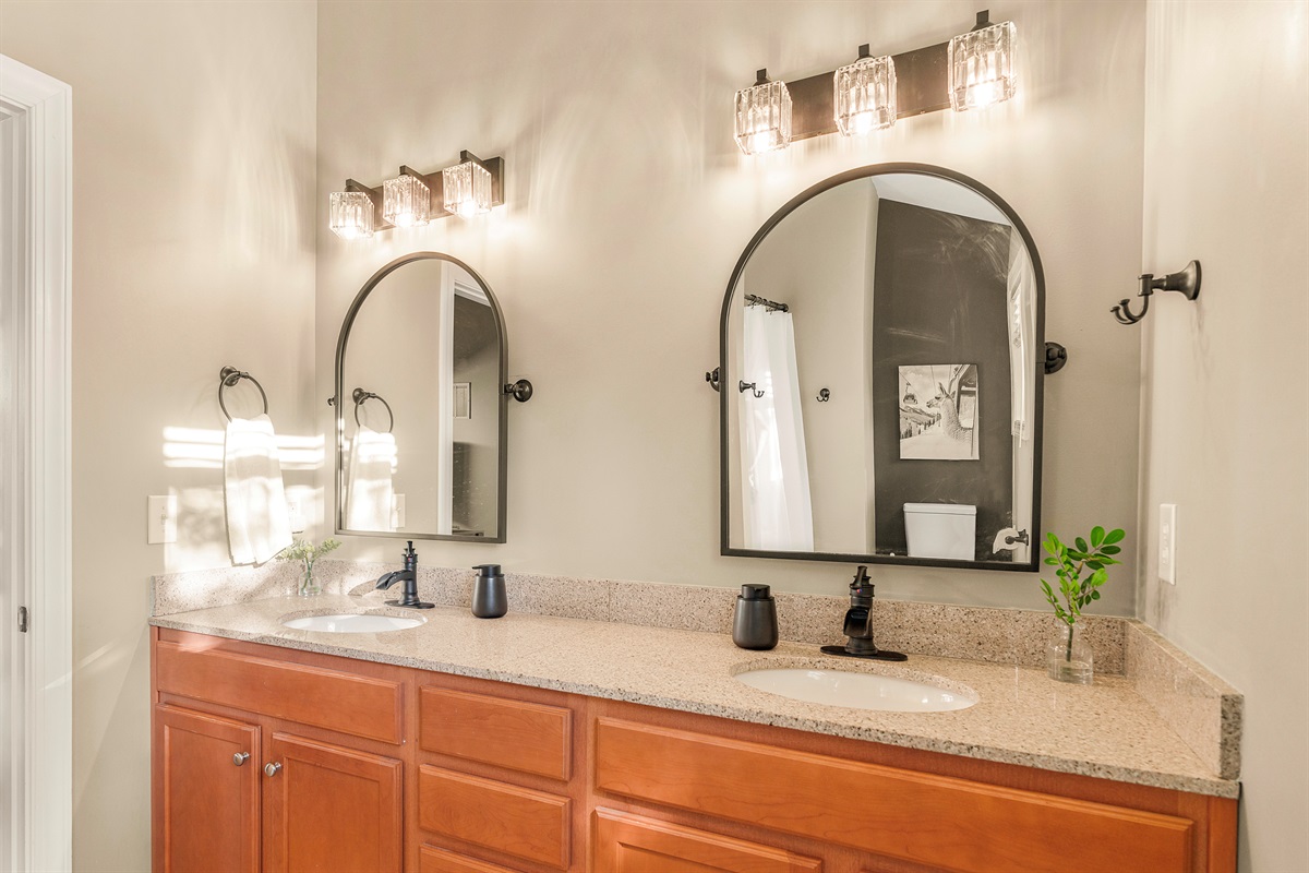 Modern, bright, and private. This newly outfitted ensuite offers crisp finishes, dual mirrors, and sleek black fixtures—designed for convenience, finished with flair