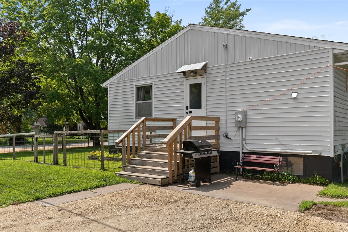 Enjoy the patio and grill area, with more seating around the backyard fire ring.