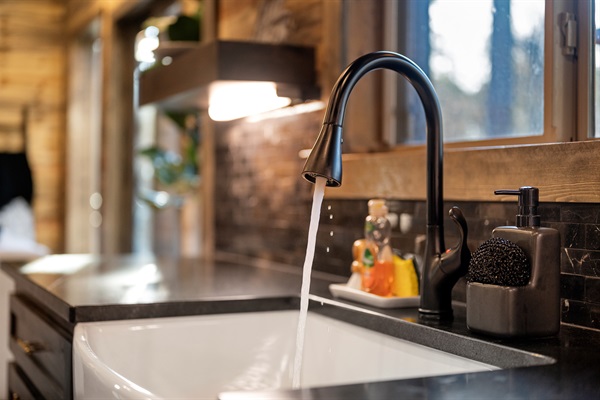 A farmhouse sink with a forest view — washing dishes never looked so good.