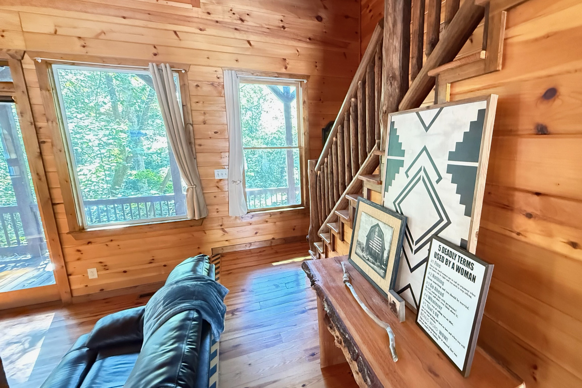 Leading to the main level bedroom with loft above and staircase to the upper level