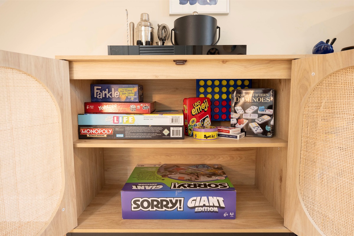 A cabinet filled with cozy classic games and puzzles - ideal for rainy afternoons, sunny‑day downtime, or just some fun family moments.