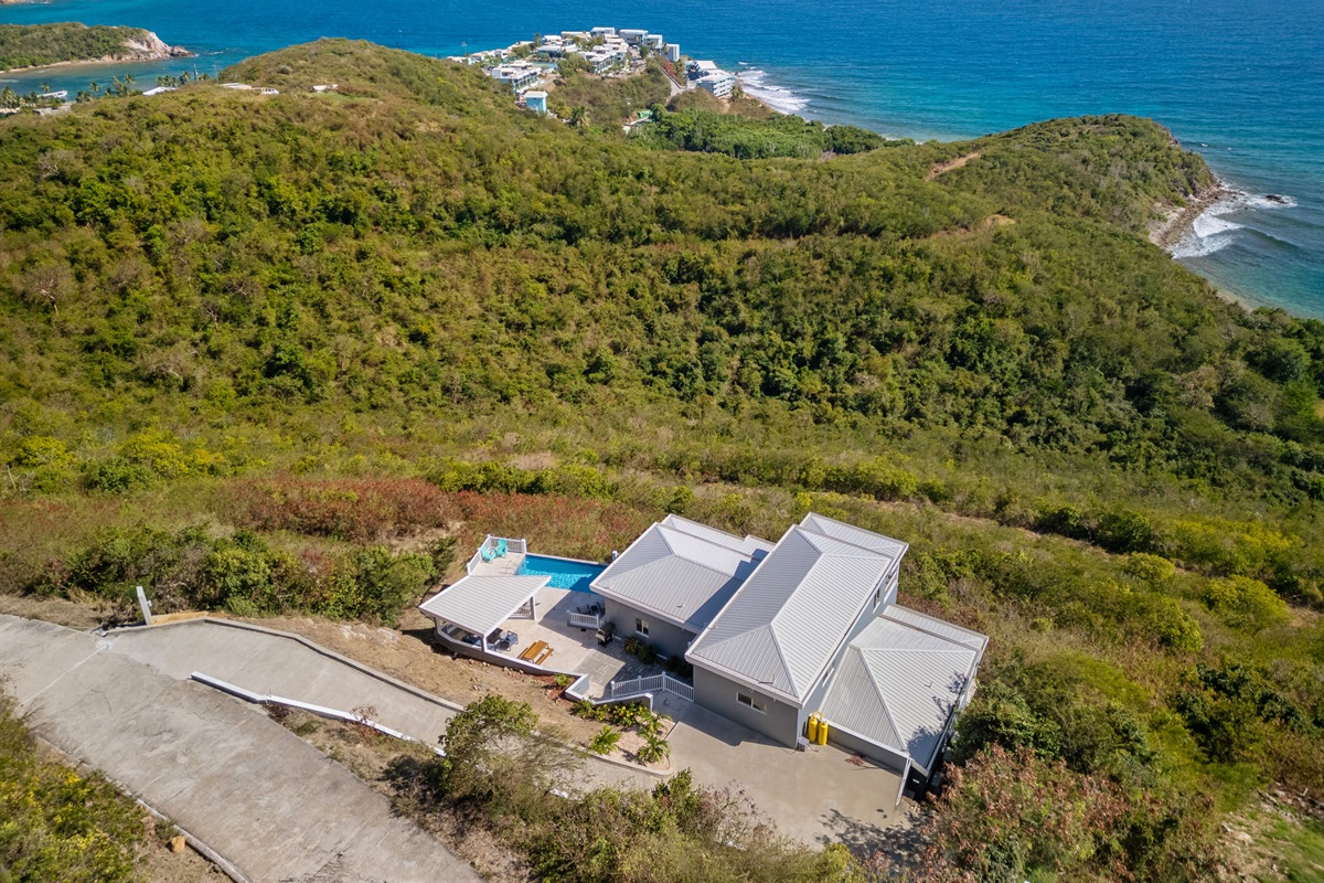 Wide perspective of the property nestled in tropical beauty.