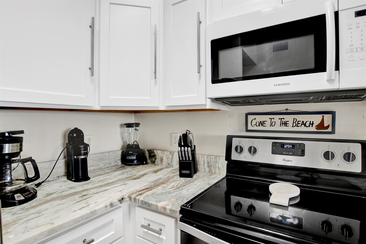 Kitchen with stainless steel appliances, granite tops and beautiful gulf view.