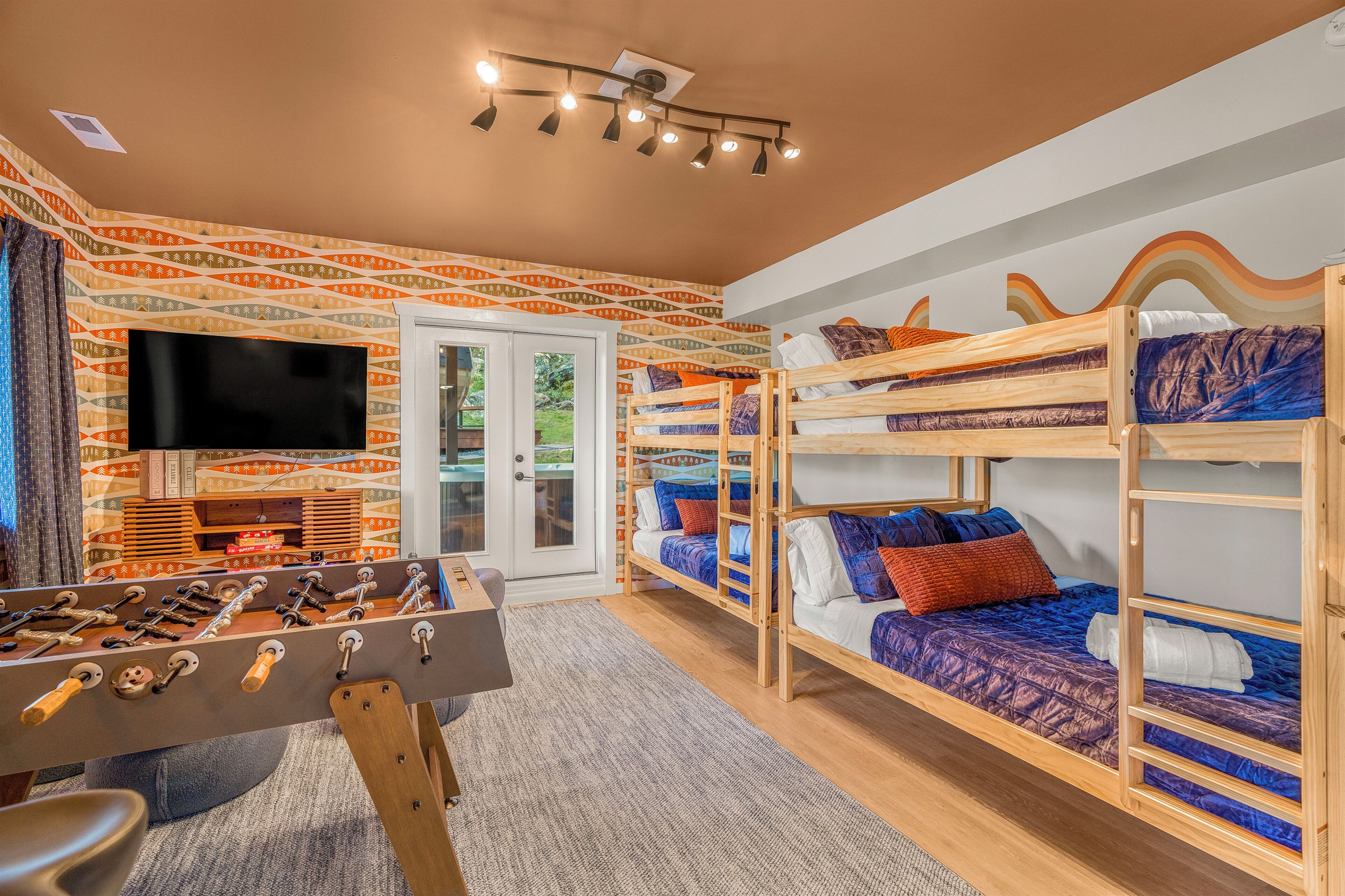 BR5: Two sets of queen-over-queen bunk beds, plus foosball, infinity game table