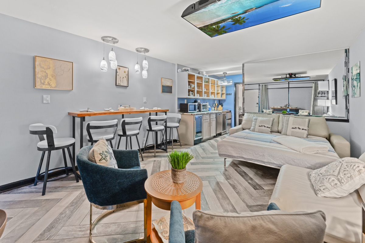 Plenty of seating with leather sofa, and occasional chairs, and bar top seating
