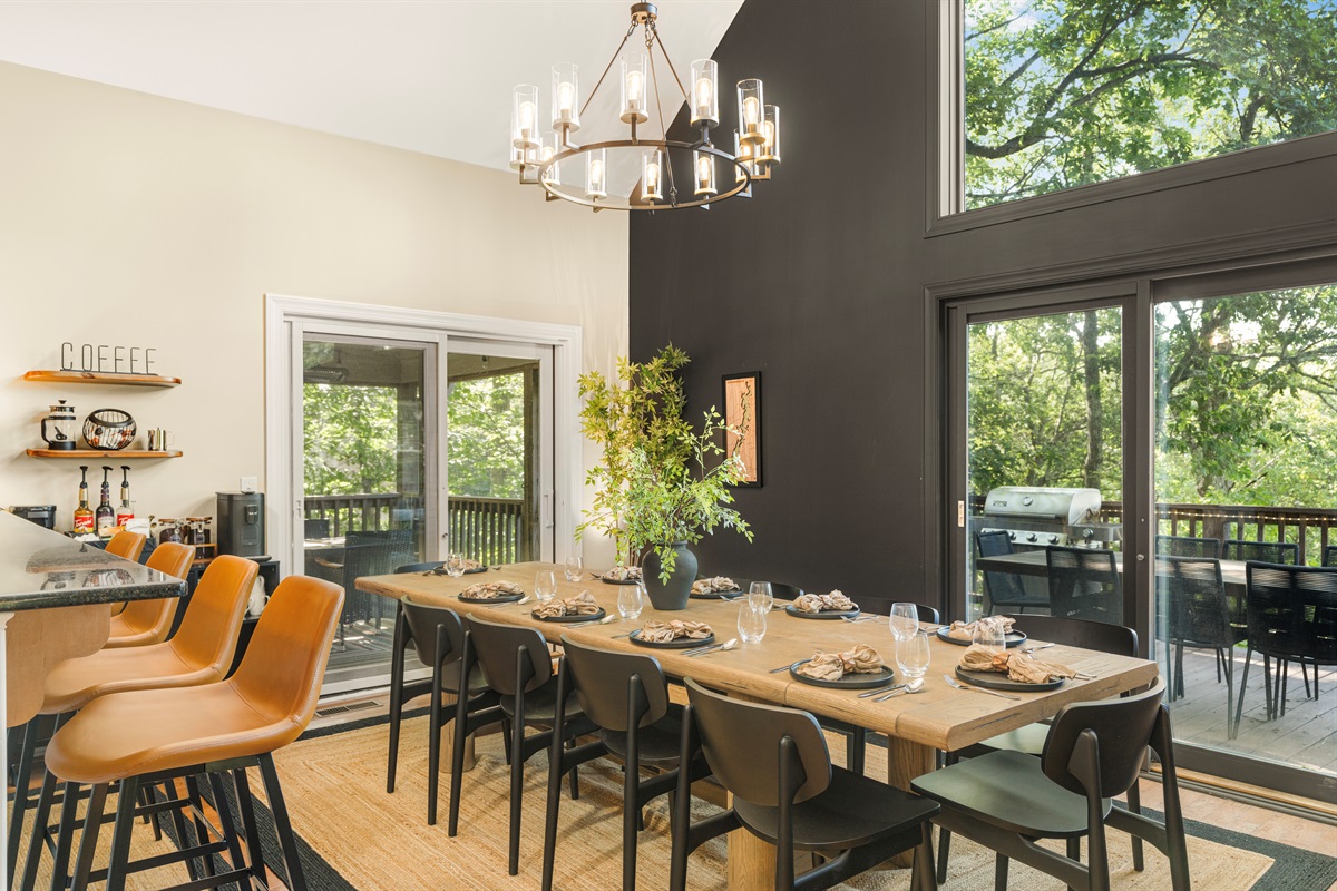 Dine under the trees — even indoors. This view-facing table seats up to 10 in elevated style, with nearby bar seating for 7 more