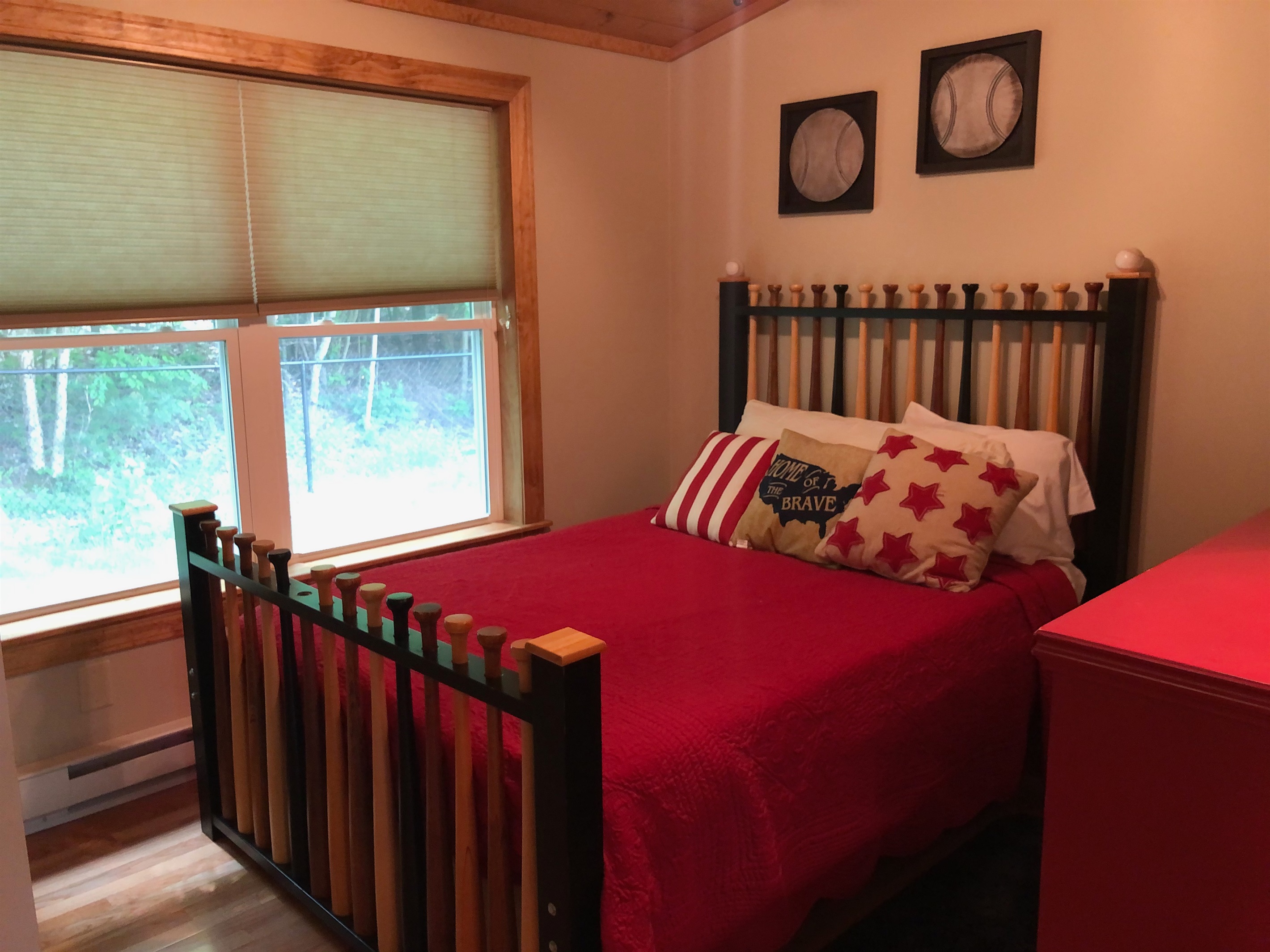 Queen bedroom with baseball décor.