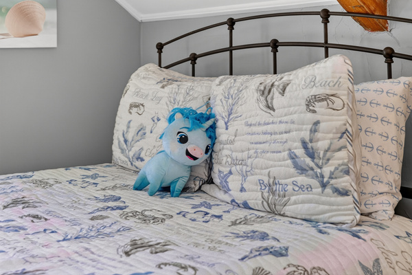 Plush bed with premium linens and thoughtful coastal-inspired accents for a restful night's sleep.