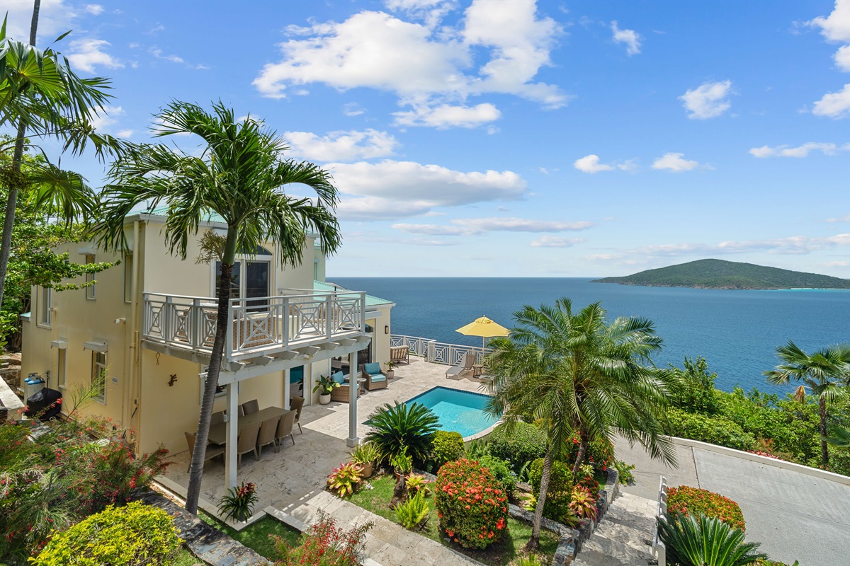 Charming island villa exterior with tropical plants and free parking. A beautiful welcome, every time.