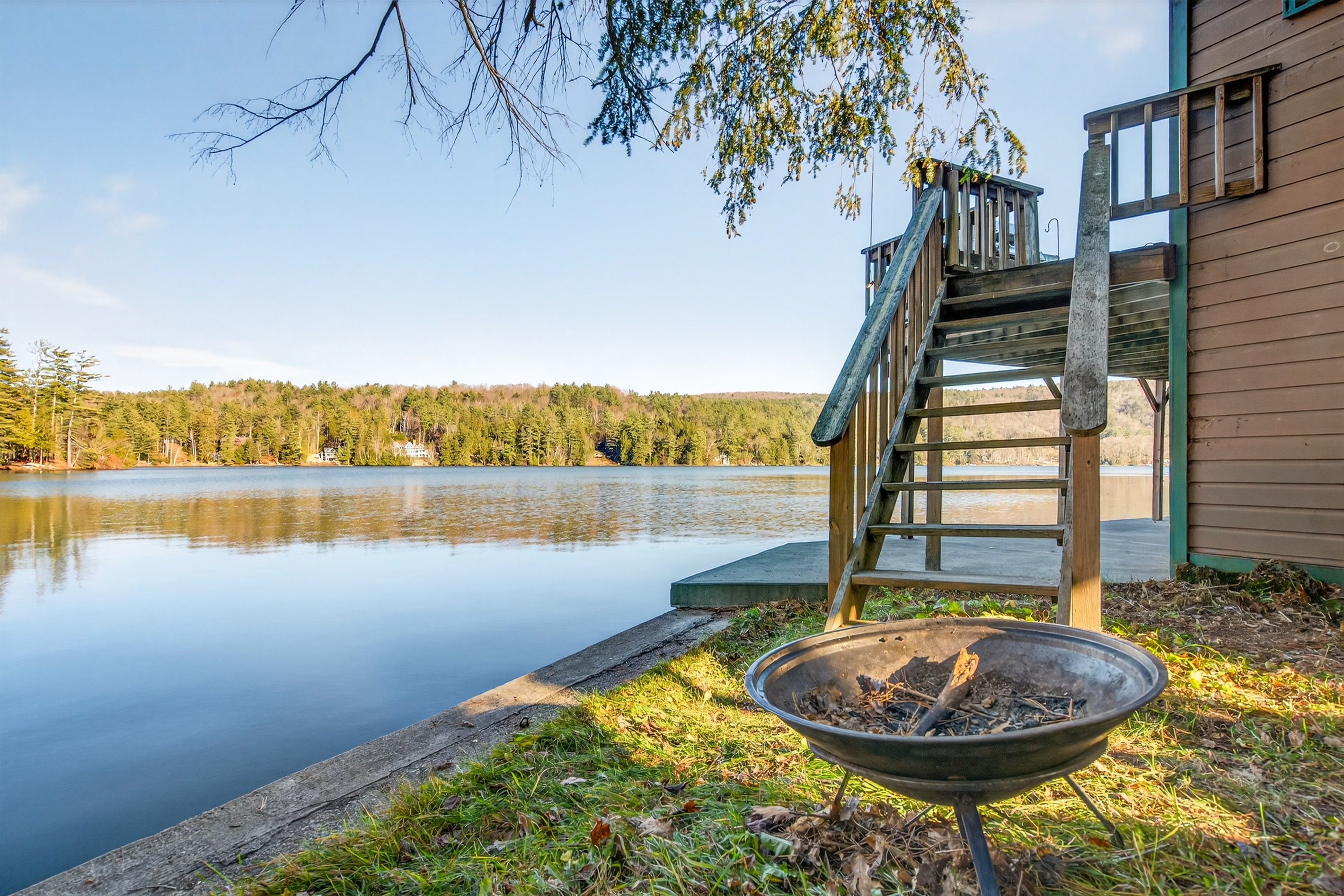 Cozy lakeside fire pit area perfect for evening gatherings — enjoy roasting marshmallows, relaxing under the stars, and taking in the peaceful waterfront views.