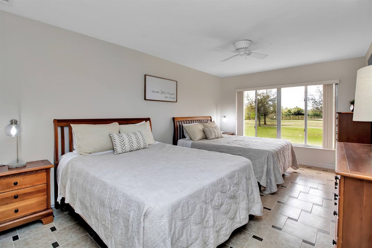 Two queen beds with individual nightstands & dressers.