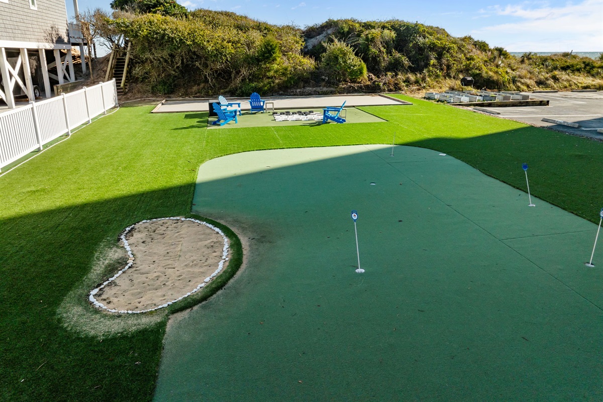 Recreation lawn near the dunes! A relaxing outdoor area with games, seating, and coastal views