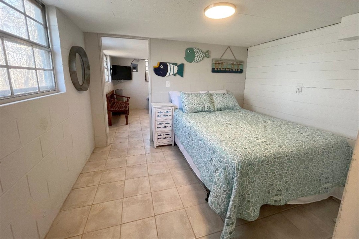 Downstairs bedroom with a queen bed
