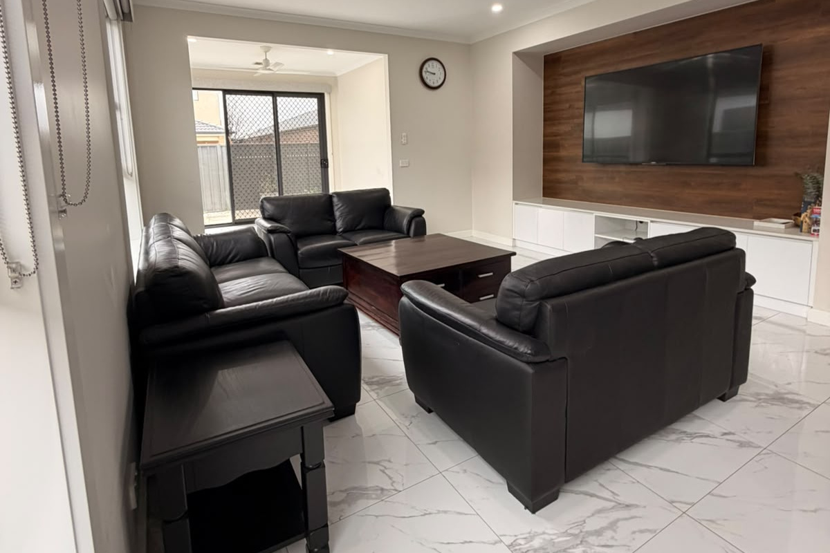The living room connects easily to the courtyard-facing doors, bringing natural light into the space and keeping the home feeling open.