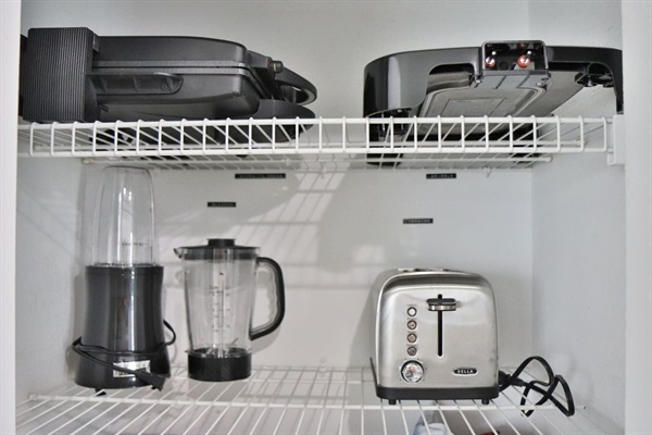 Sandwich press, skillet, blender and toaster can be found in the pantry