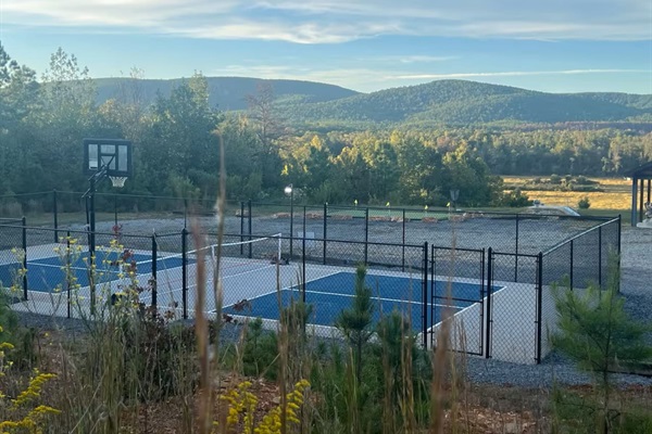 Pickleball, basketball, and putting green set against a dramatic mountain backdrop.
