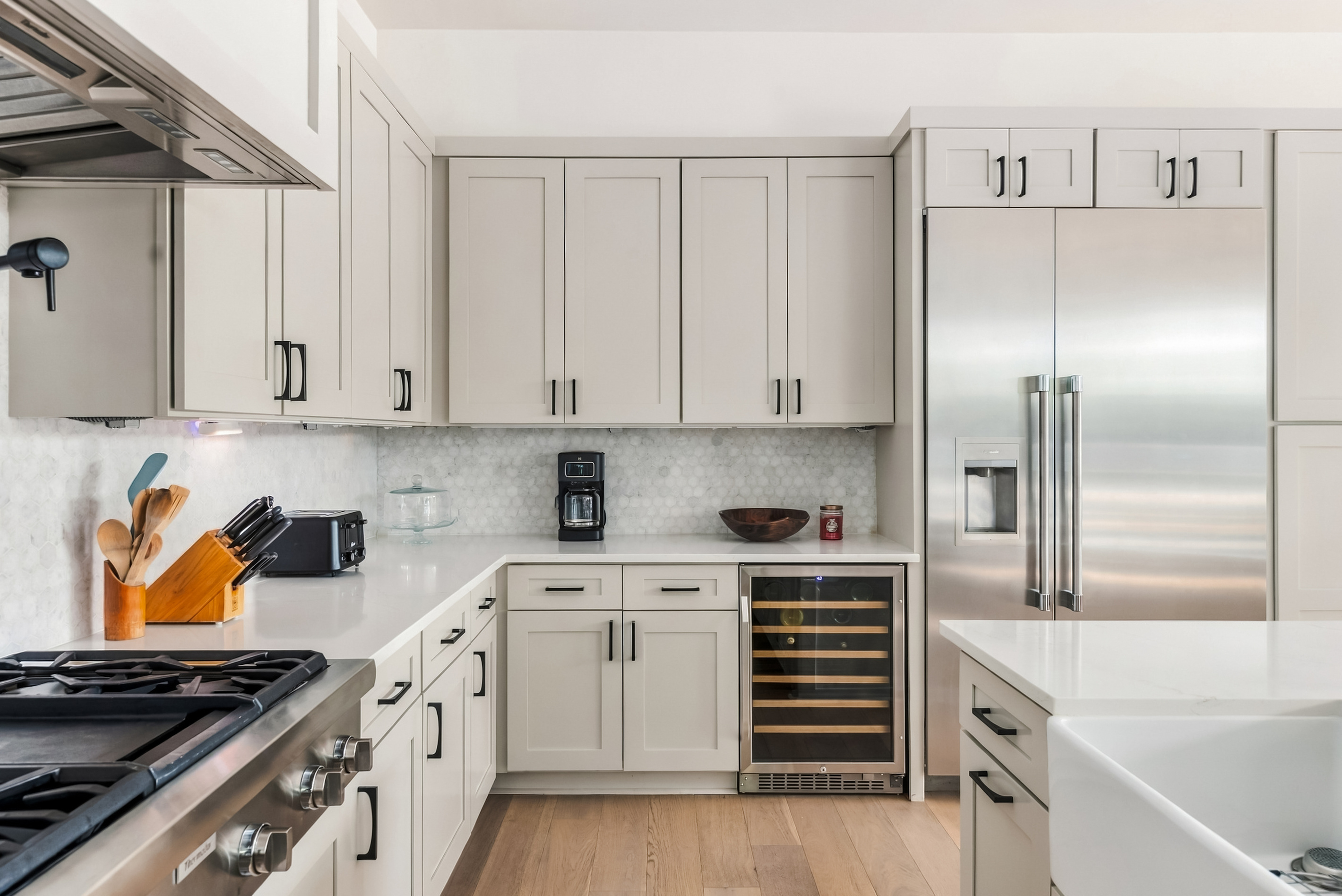 Stainless range and built-in wine fridge make this kitchen truly chef-ready.
