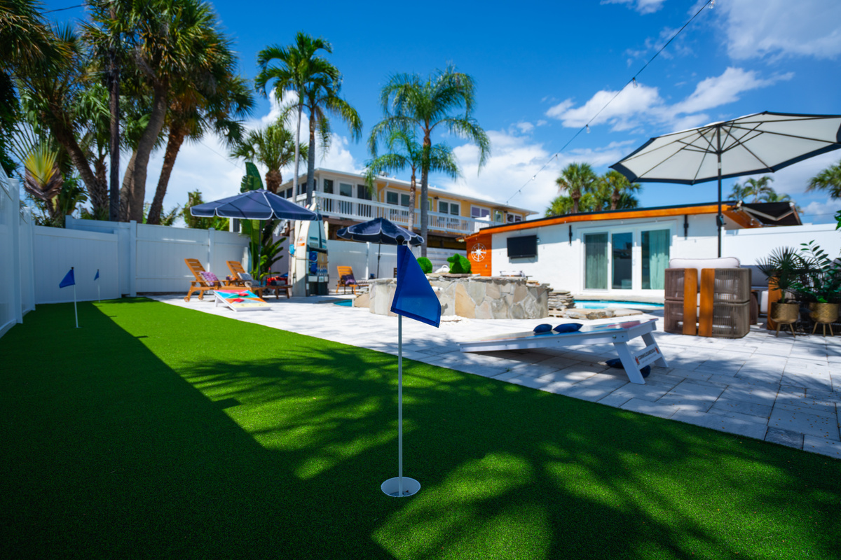 IRB Sailhouse backyard has something for everyone, backyard putting green, cornhole and shaded lounging.