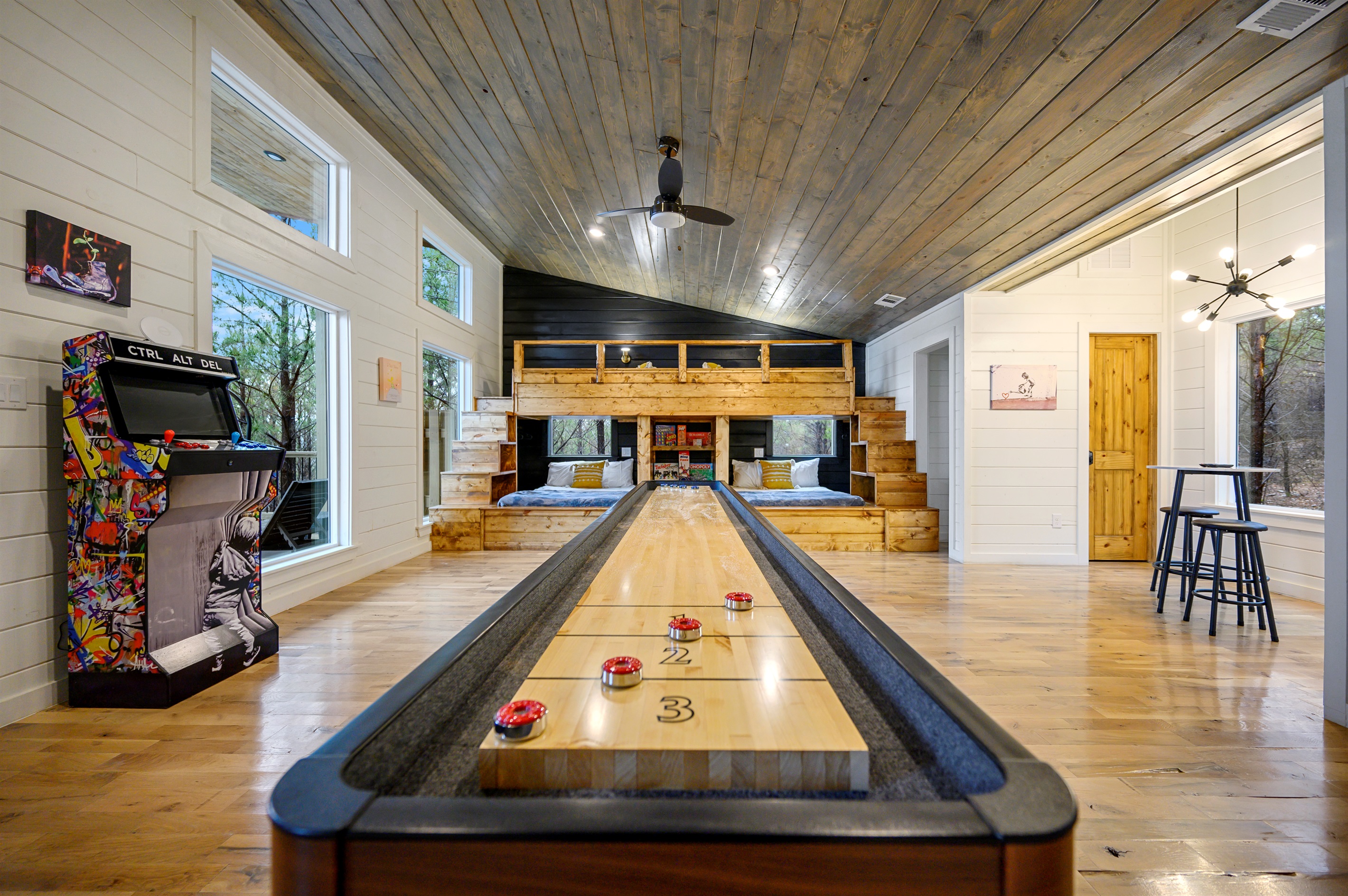 A lively game area featuring over 100 arcade games and a shuffleboard table — perfect for endless entertainment, friendly competition, and group fun indoors. 🎮🏓✨