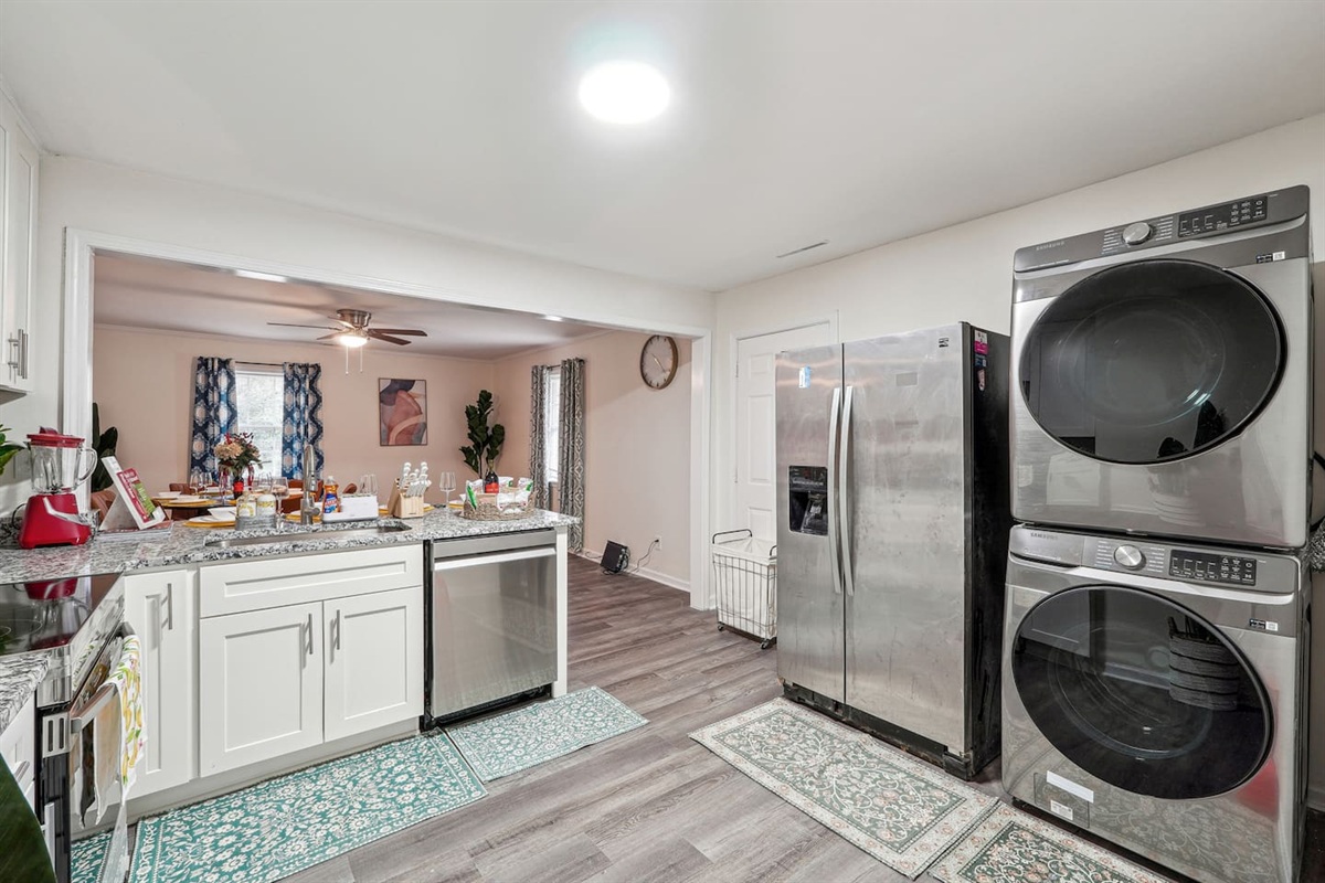 A convenient laundry area featuring a washer, dryer, and laundry essentials like detergent and fabric softener — perfect for guests who need to do laundry during their stay.
