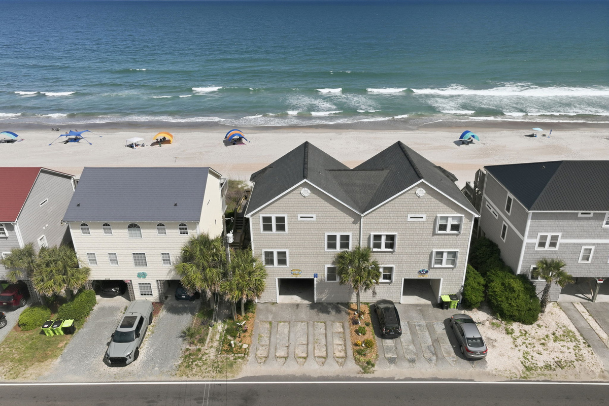 Beachfront aerial showing homes along the shoreline