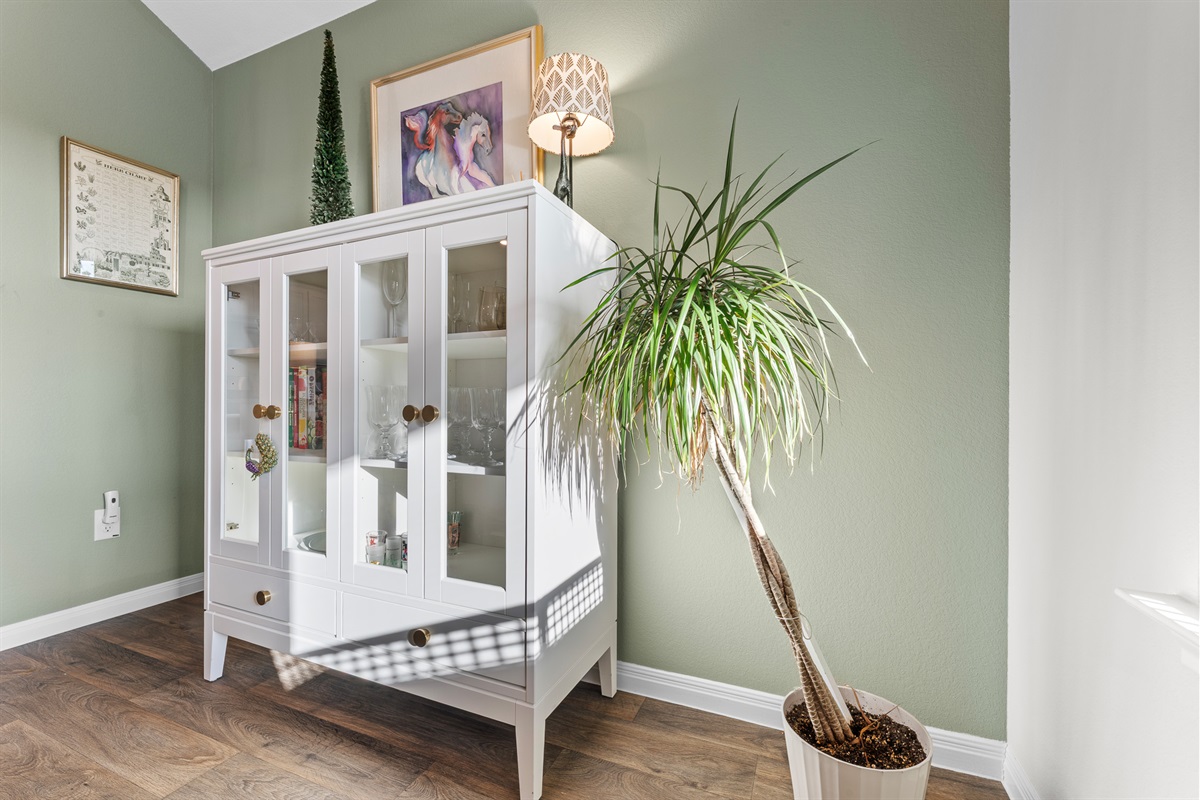 Having a bottle of wine find the wine glasses right beside the dining table