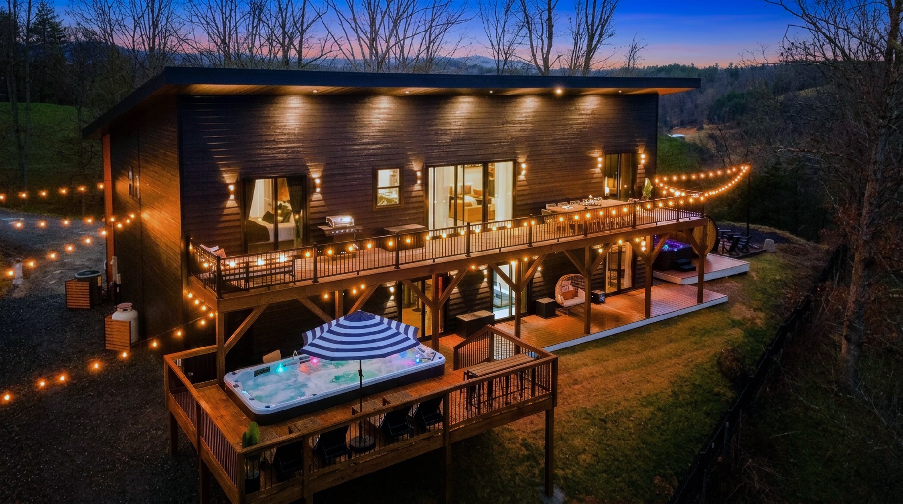 {Welcome} Nighttime at Summit House — soak in the swim spa on the elevated deck beneath glowing string lights, sharing stories over a glass of wine with mountain views all around. The perfect way to unwind and end the night.