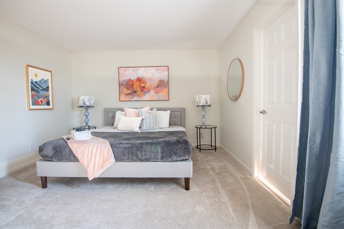 Another great view of the thoughtfully designed, serene king bedroom with an open, relaxed feel just off the dining room.