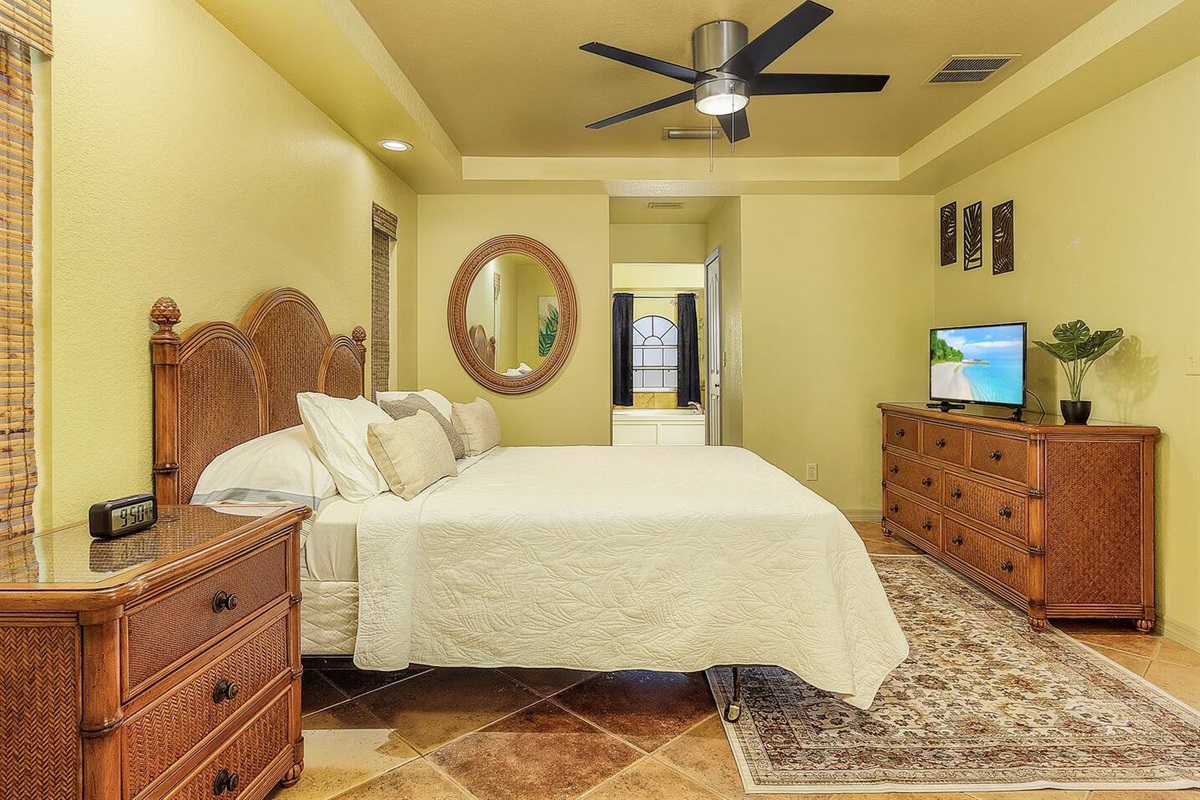 Indulge in a plush queen-size bed and tropical decor in the primary suite!