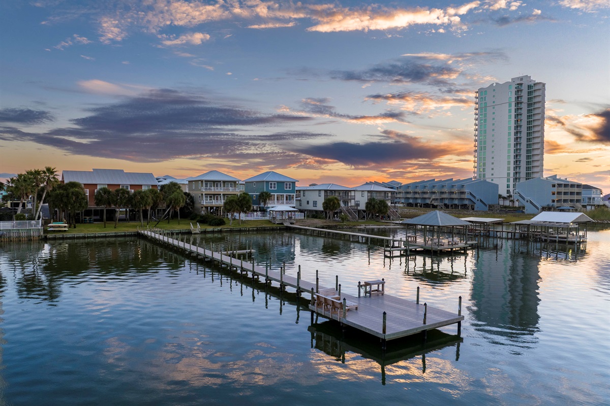 Sunset serenity: Tranquil waterfront homes and docks reflecting on still waters in Gulf Shores, Alabama.