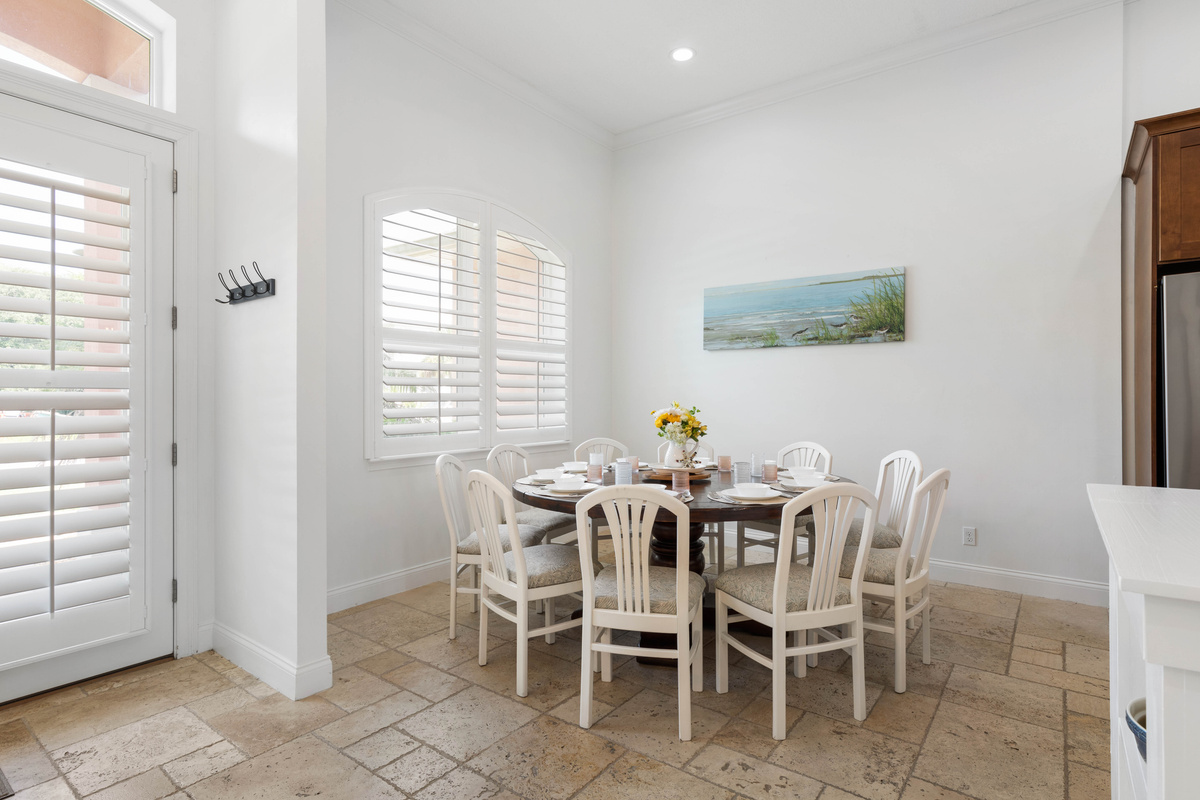 An arched, shuttered window brightens the dining area, a good spot for long dinners, board games and morning plans.
