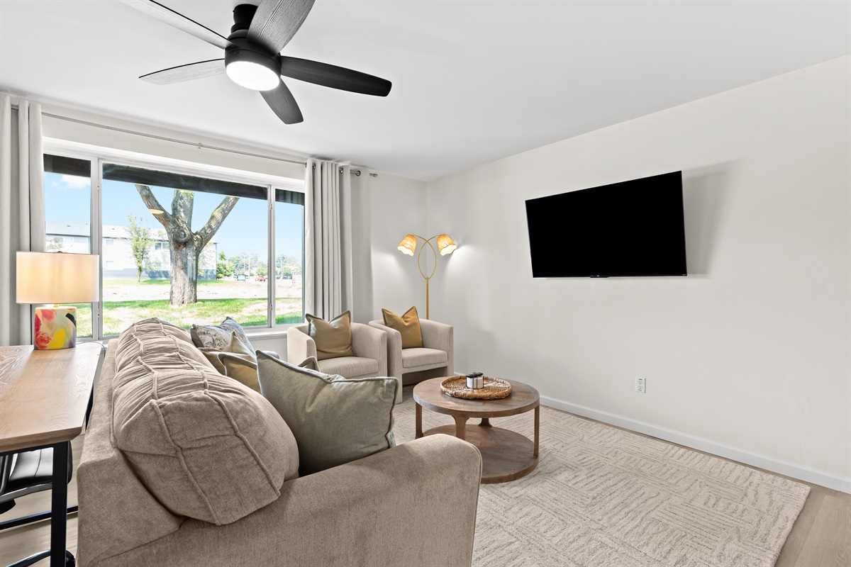 The open and airy living space is ideal for lounging with loved ones or enjoying a movie night after a day of exploring.