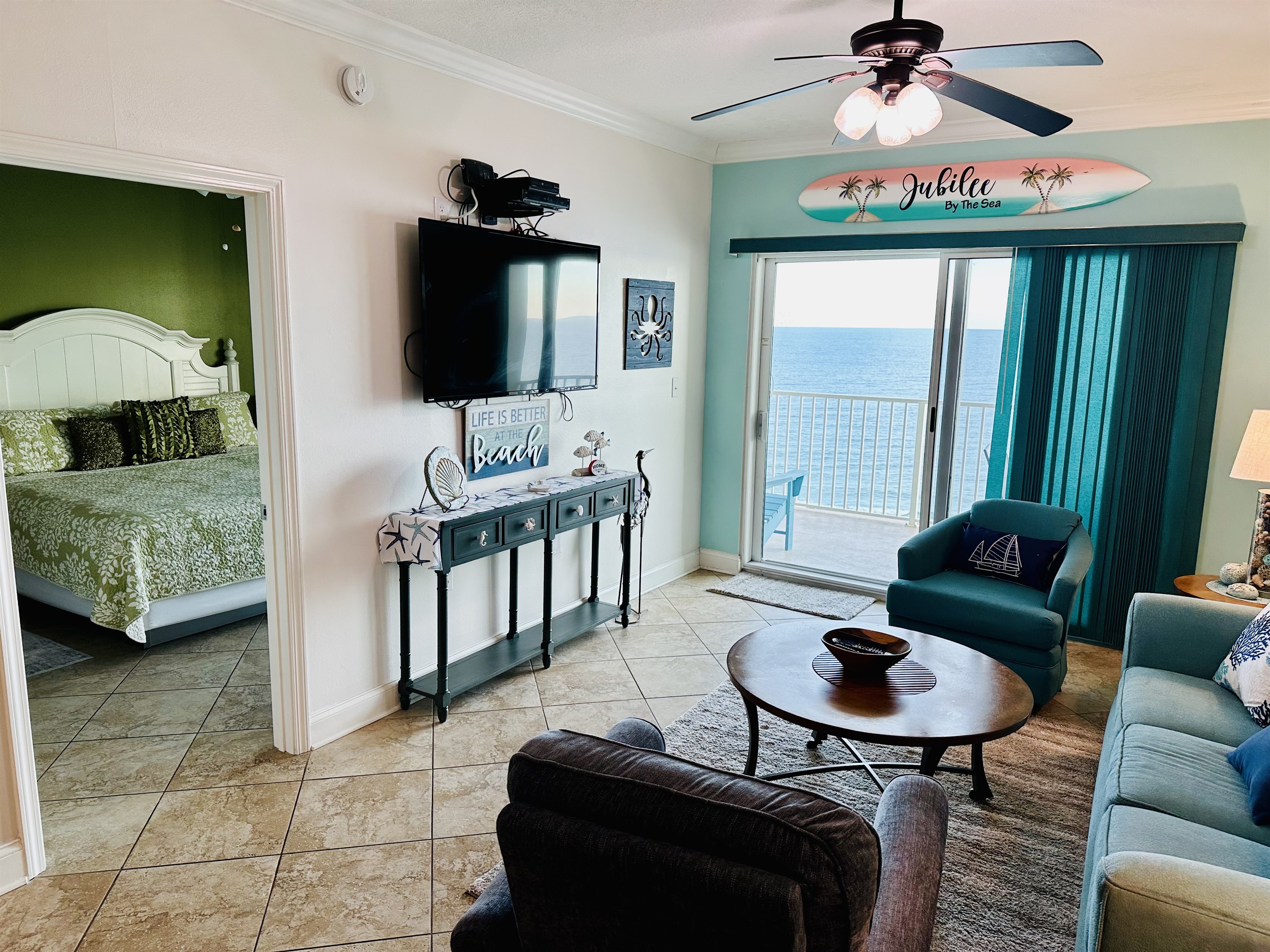 Living room sleeper sofa, 2 end tables, coffee table 2 arm chairs, ceiling fan and a 55" wall mounted Smart TV and a great direct Gulf view