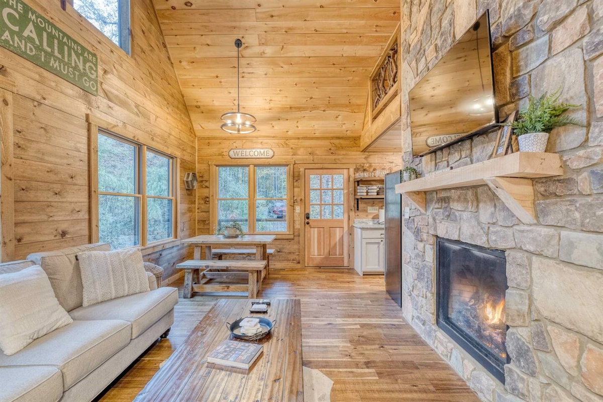 Our fireplace, nestled beneath the glow of the flat screen TV, creates the perfect setting for warm gatherings and relaxed entertainment, where flickering flames meet captivating stories.