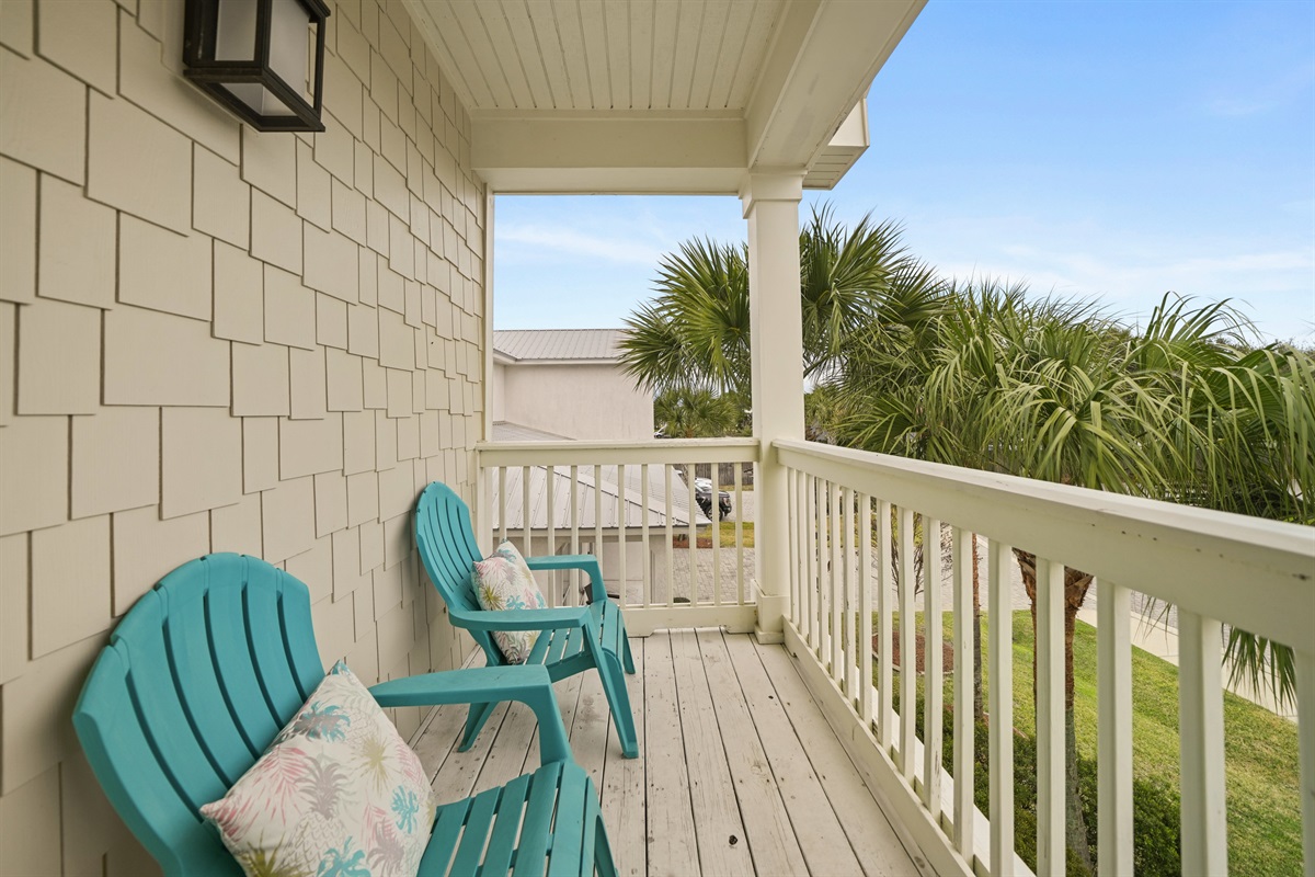 Private upstairs balcony located off the grand king suite with seating and views of the neighborhood. 