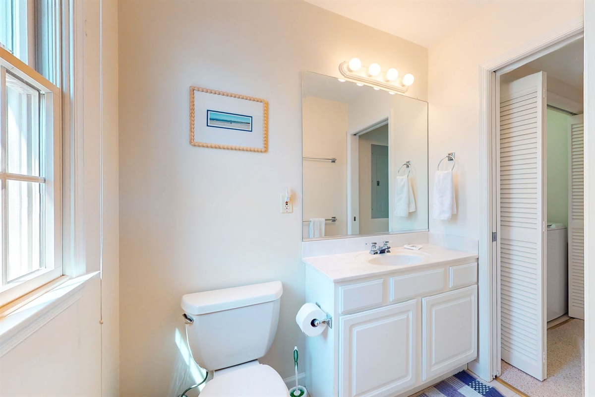 Half bathroom with access to laundry area