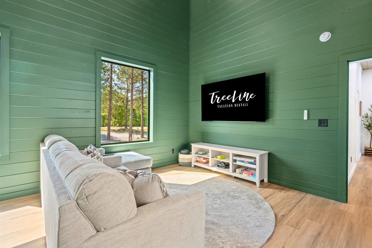 Comfortable seating and warm finishes give this secondary living space a relaxed cabin feel everyone can enjoy.