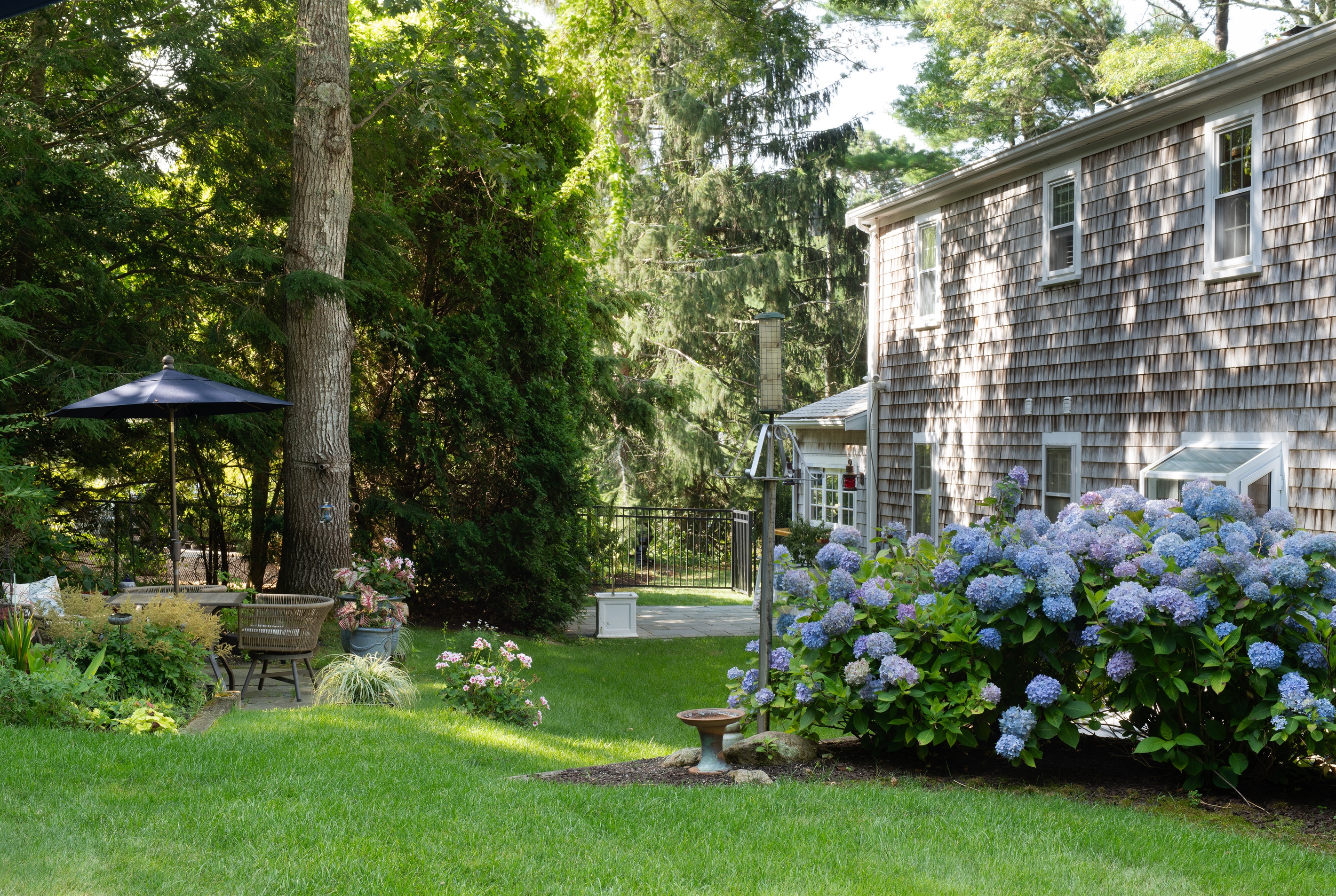 Take in the beauty of the garden from this cozy outdoor seating spot.